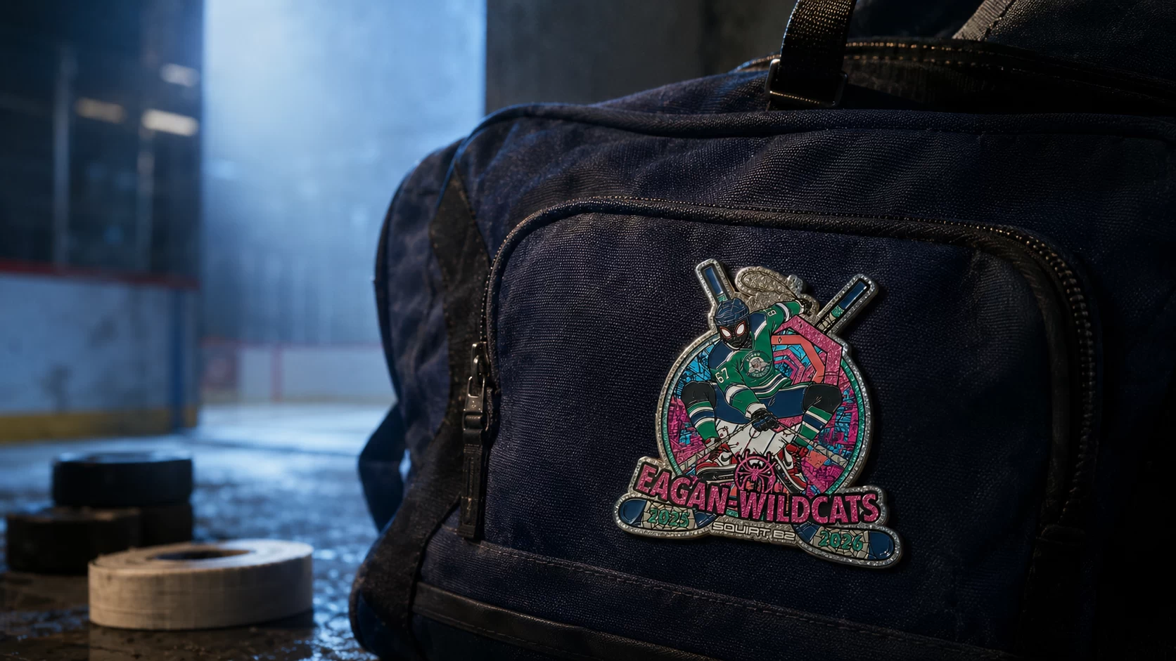 Art-directed lifestyle visualization of an Eagan Wildcats hockey pin attached to an equipment bag beside an ice rink.