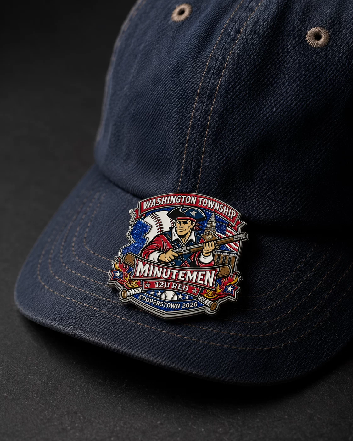 Art-directed lifestyle visualization of a Washington Township Minutemen pin attached to a navy baseball cap.