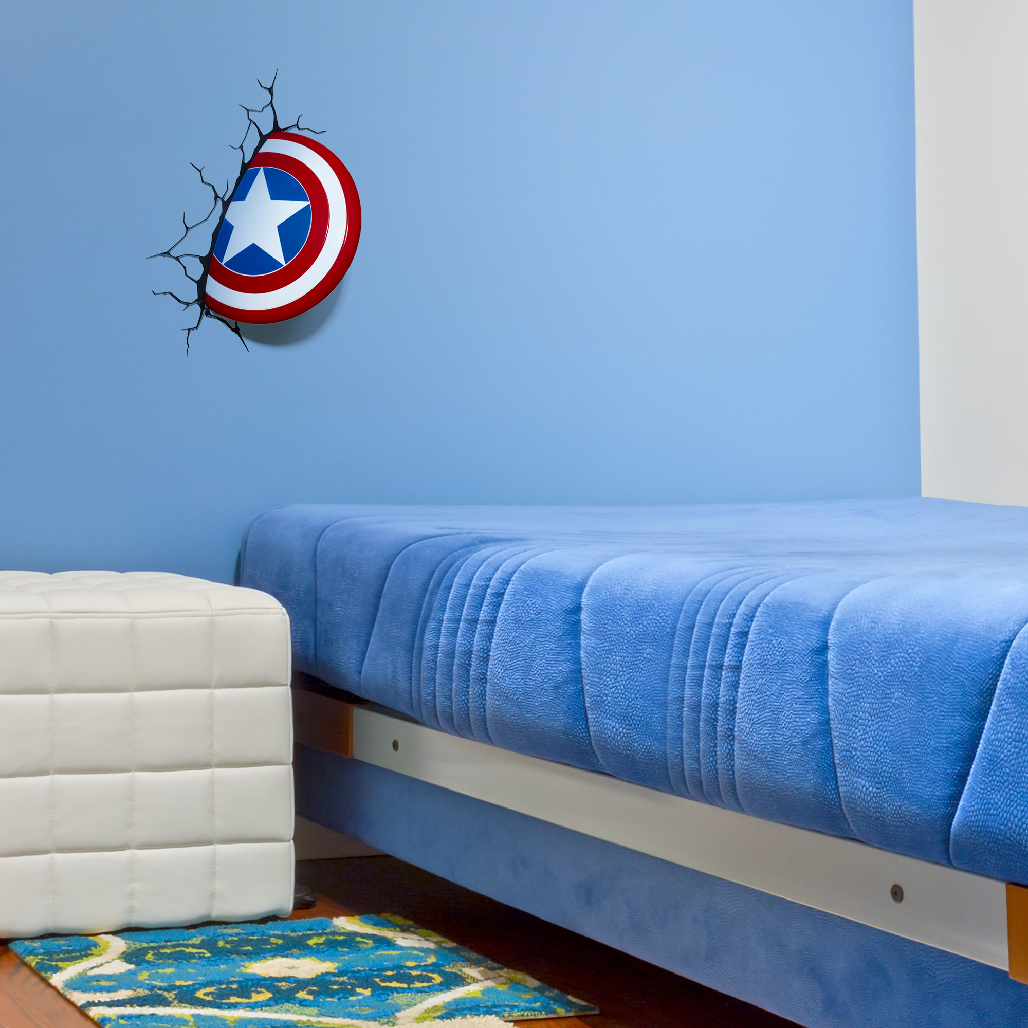 Captain America shield light installed on a blue bedroom wall